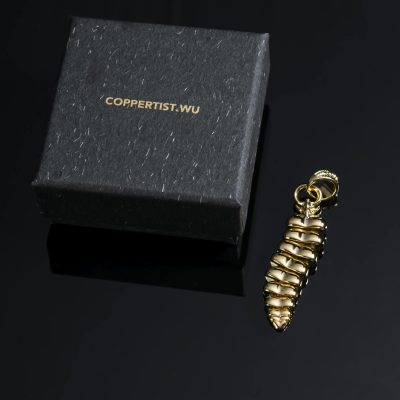 A sophisticated gold dragon tail pendant displayed next to a COPPERTIST.WU gift box.