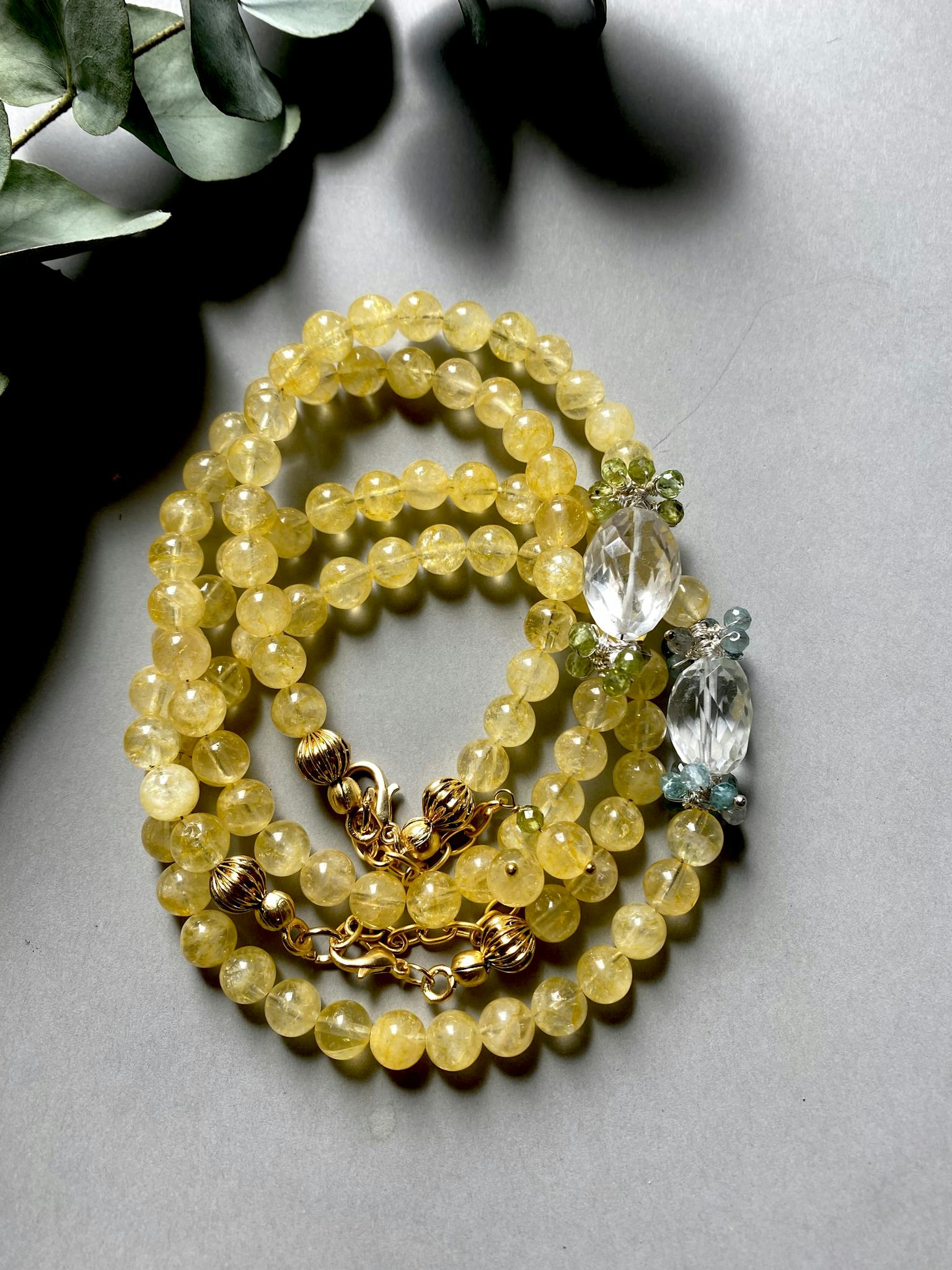 Elegant yellow beaded necklace with crystal embellishments, showcasing artisan craftsmanship in natural lighting.
